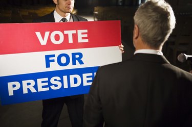 Politician with Vote For President sign