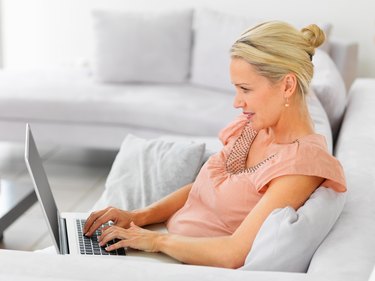 Mature woman using the laptop to browse the internet