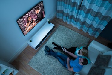 Couple Watching Movie In Living Room