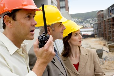 Foreman with architects at construction site