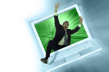 Businessman struggling with laptop computer