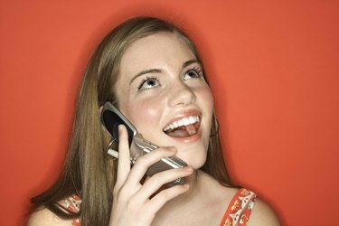 Cheerful woman talking on cell phone