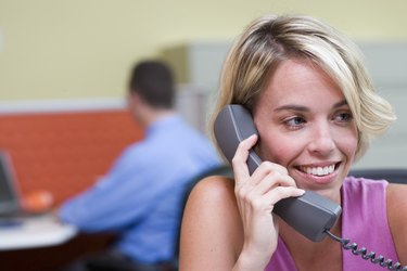 Close-up of a businesswoman talking on a telephone in an office