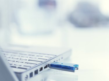 Laptop on desk with adaptor, close up