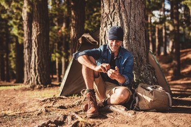 Senior man sitting at campsite