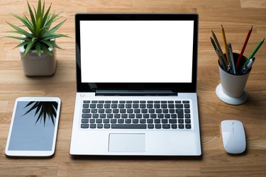 Technologies With Office Supply On Wooden Desk