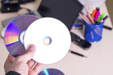 hand holding white blank CD DVD disk