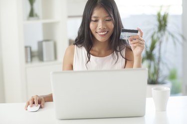 Smiling Asian Woman Shopping Online