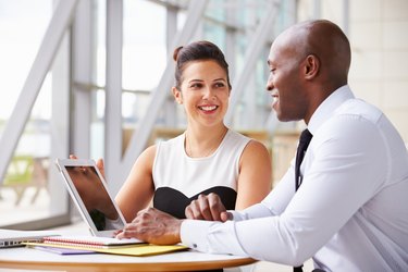 Two corporate business colleagues working together in office