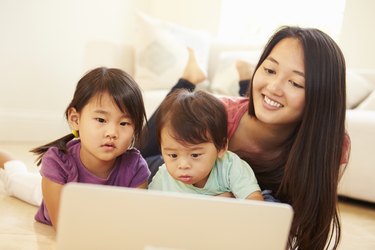 Mother And Children Using Laptop Together