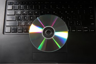 Top angle view of a CD and a laptop