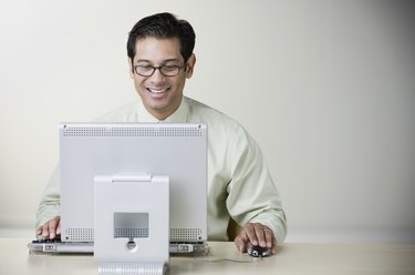 Hispanic man using computer at table