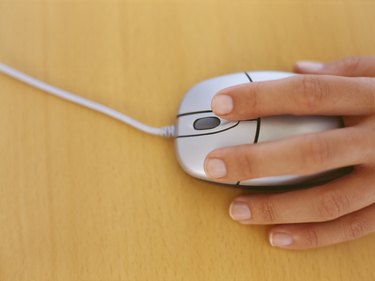 high angle view of a human hand holding a computer mouse