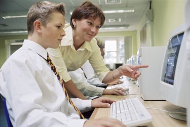 Teacher and student with a computer