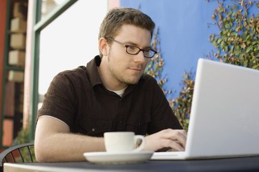 Hipster man using laptop computer