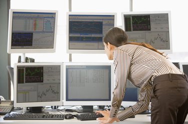 Stock Trader Examining Computer Monitors