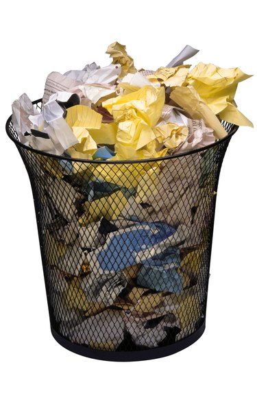 Waste basket filled with crumpled paper