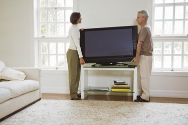 Couple moving flat screen television