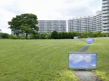 Flat TV placed in front of urban apartments