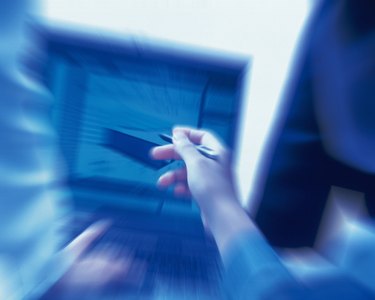 Photography of Three people working together with a computer at the desk, Portrait, Rear View, Toned Image, Blurred Motion