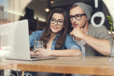 Couple enjoying the wireless internet at cafe