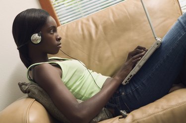 Side profile of a teenage girl operating a laptop