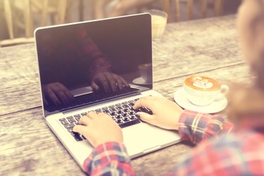 Girl with laptop and cup of coffee, vintage photo effect