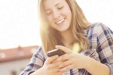 Young girl texting on the phone