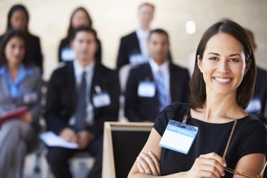 Businesswoman Delivering Presentation At Conference