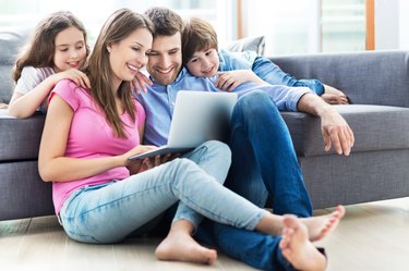 Family using laptop at home