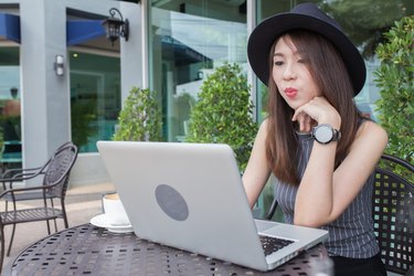 woman using laptop in coffee shop ,asian