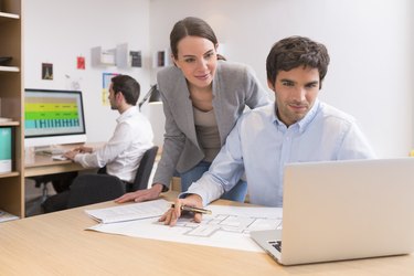 Business team working on laptop in office