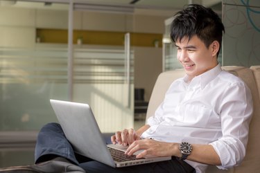 Young man on the sofa with a laptop