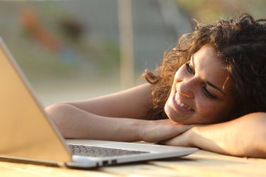 Woman watching media in a laptop
