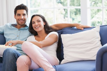 Attractive couple watching tv on the couch