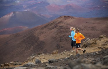 Fitness sport couple running jogging outside on trail