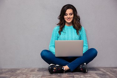 Woman using laptop computer on the floor