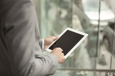 Hands holding a digital tablet