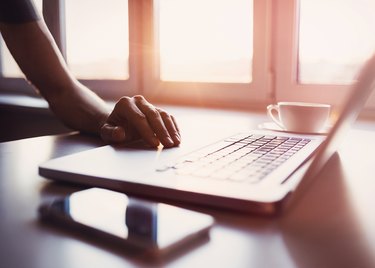 Male hand on laptop keyboard