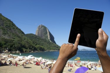 Brazilian Hands Using Tablet at Sugarloaf Rio de Janeiro Brazil