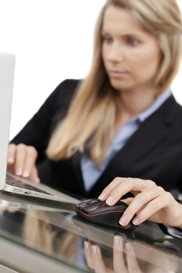 Beautiful young businesswoman using laptop