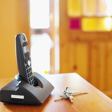 close-up of keys and a cordless phone on a table