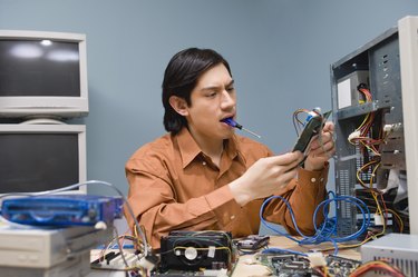 Tech support worker repairing computer