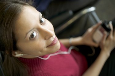 Woman listening to portable device