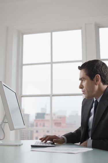 Businessman sitting at desk with computer