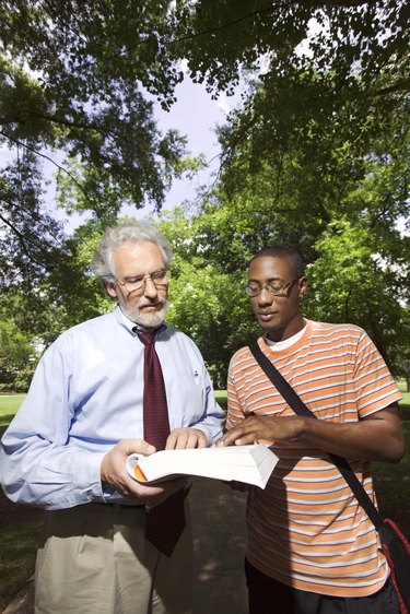 Professor helping student outdoors