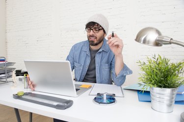 corporate portrait  young hispanic hipster businessman working at office