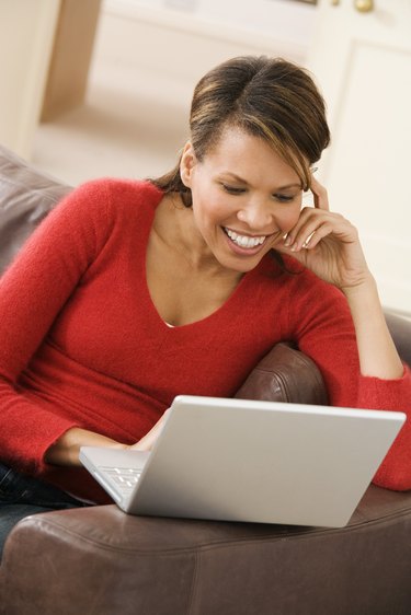 Smiling woman with laptop computer