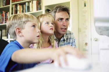 Father and children playing computer