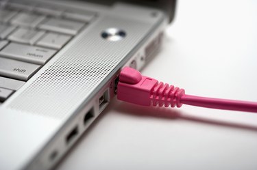 Studio shot of laptop with cable plugged in